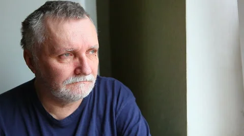 Sad serious man looking out the window. Loneliness concept Stock Footage 63489510