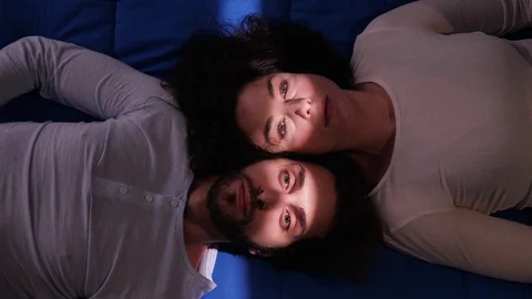 Sad silent young couple lying on bed at night.crisis, incommunicability Stock Footage 103602142