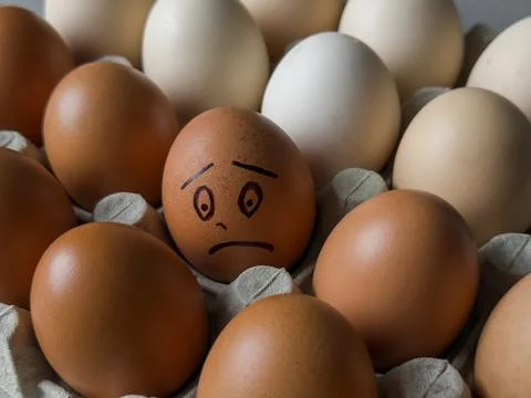 Sad smile drawn on egg Foto stock
