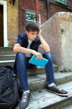 Sad Student with the Book Stock Photos