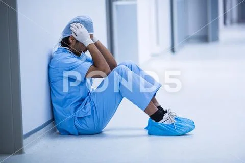 Sad surgeon sitting on a floor Stock Photos