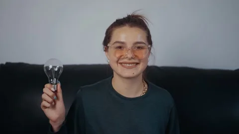 The sad, thoughtful red-haired young woman looks ahead, smiles broadly when she Stock-Footage 163758258