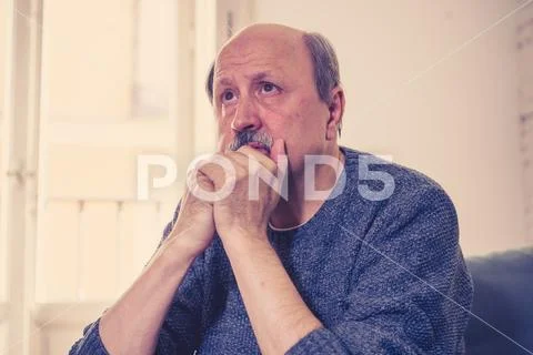 Sad unhappy old senior man suffering from memory loss and alzheimer feeling d Stock Photos