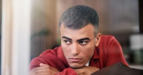 Sad, upset and man by window in home with ideas, mental health or anxiety o.. Stock Photos