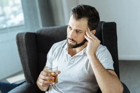 Sad upset man drinking alcohol Stock Photos