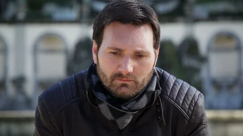A sad, upset man in the middle of an arcade looking at the camera Stock Footage 102281350