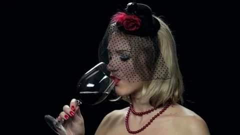 Sad widow drinking wine on black background Stock Footage 82636220