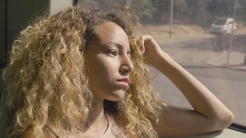 Sad woman on the bus looking out the window Stock Footage