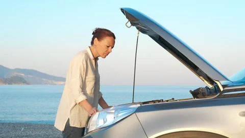 Sad woman by car with problems by river. Stock Footage 305324427