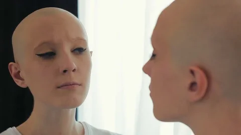 Sad woman in chemotherapy is concerned and worried about her look Stock Footage