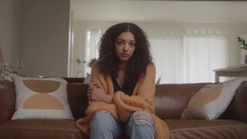 Sad Woman on the Couch Looking up to the Camera Stock Footage 208781047