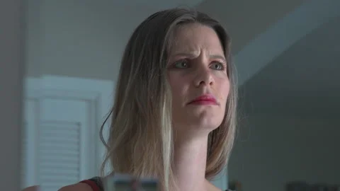 Sad woman cries while looking into the mirror Stock Footage 280589321