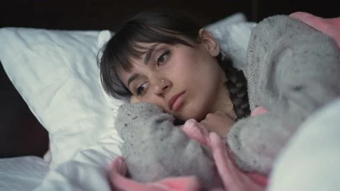 Sad woman lying in a bed Video stock 155198853