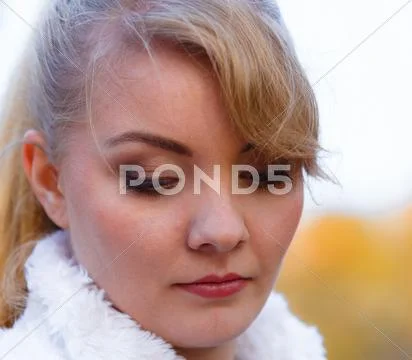 Sad woman spend time in autumnal park. Stock Photos