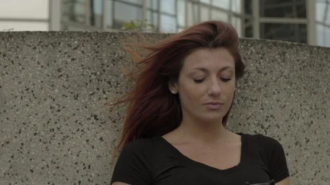 Sad Woman using smartphone Sitting in business district, worried while texting 動画素材 111925562