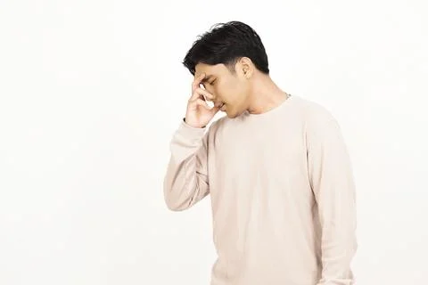 Sad Young Asian Man Gesturing Headache with Closed Eyes Fotos de archivo