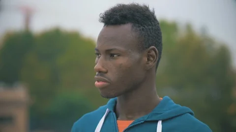 Sad young black migrant staring at camera. outdoor. Depression,sadness Stock Footage 98232018