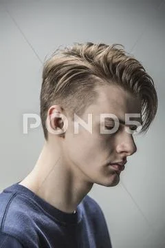 Sad young man against gray background Stock Photos