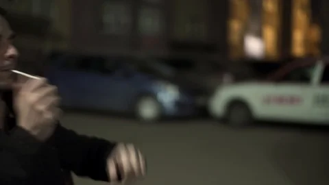 A sad Young man sets fire to a cigarette. Depression. Nervously Smoking a Stock Footage 90403515