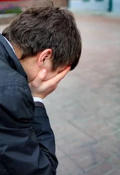 Sad Young Man Side view of Sad Young Man with hidden face outdoor ,model r... Foto stock