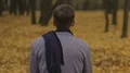 Sad young man sitting alone in gloomy autumn park, feeling unhappy and lonely HD Footage