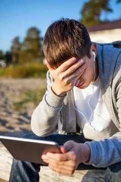 Sad Young Man with a Tablet Stock Photos