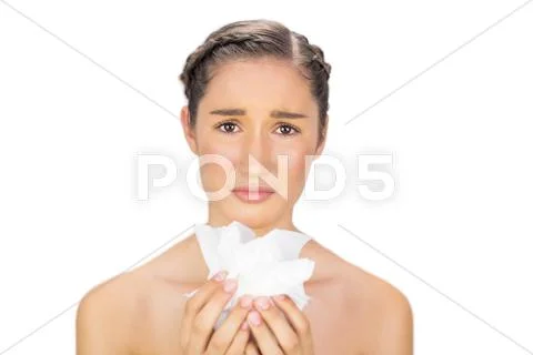Sad young model holding loads of tissues Stock Photos