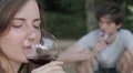sad young woman drinks red wine and reflected on his couple relationship HD Footage