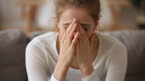 Sad young woman feeling stressed worried about unwanted pregnancy Stock Footage