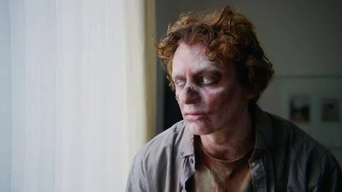 Sad Zombie Man Drinking Coffee while Looking out of Window Stock Footage 293767865