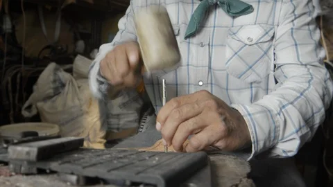 Saddler working the skin Stock Footage 96184359