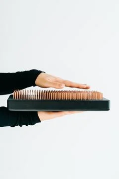 A sadhu board of their dark solid oak with copper nails, in the hands of a young Stock Photos