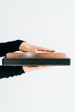 A sadhu board of their dark solid oak with copper nails, in the hands of a young Stock Photos