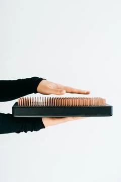 A sadhu board of their dark solid oak with copper nails, in the hands of a young Stock Photos