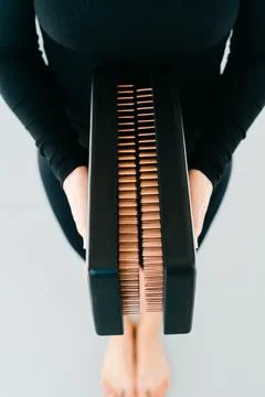 A sadhu board of their dark solid oak with copper nails, in the hands of a young Stock Photos
