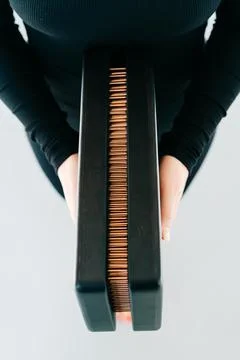A sadhu board of their dark solid oak with copper nails, in the hands of a young Stock Photos