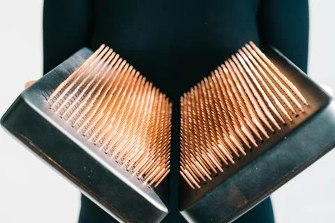 A sadhu board of their dark solid oak with copper nails, in the hands of a young Stock Photos