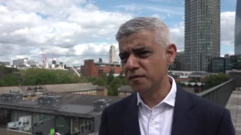 Sadiq Khan helps feed children after emergency funding programme  Stock Footage 247453537