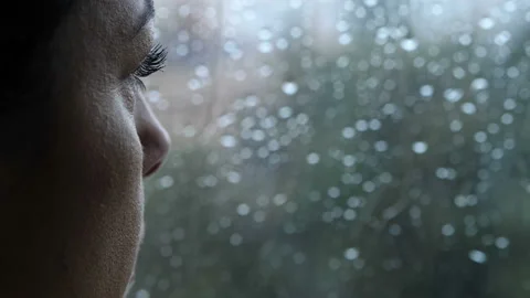 Sadness, depression - pensive woman looks out the window in a rainy day - macro Stock Footage 141548288