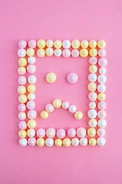 The sadness in frame in the shape of a rectangle of meringue on a pink backgr Stock Photos