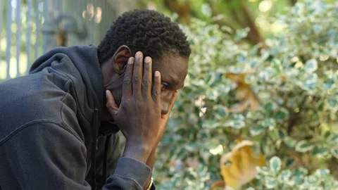 Sadness, thoughts, problems - pensive african man runs his hands over his face Stock Footage 231679514