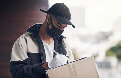 As safe and efficient as a delivery service should be. a masked young man Stock Photos