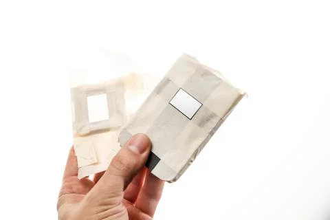 Safe applying liquid metal on CPU crystal and IHS in man's hand isolated on Stock-Fotos