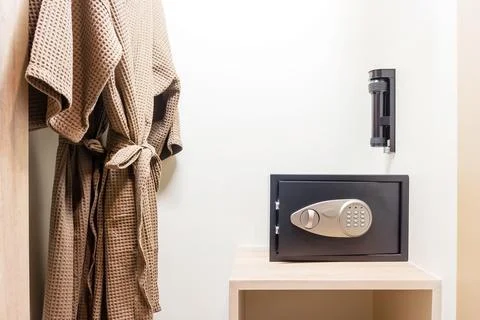 Safe box with electronic lock hidden in the wardrobe at the hotel. Stock Photos