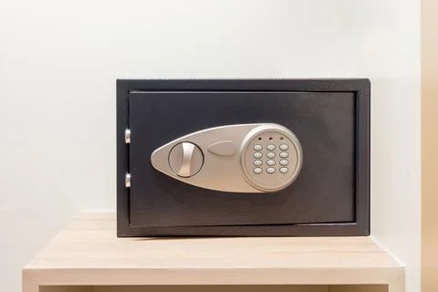 Safe box with electronic lock hidden in the wardrobe at the hotel. Stock Photos