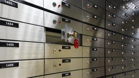 Safe deposit boxes inside bank vault. Open deposit box with key Stock Photos