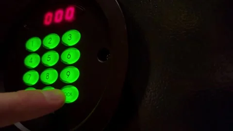 The safe door closes as a man hand presses code Stock Footage 288307169