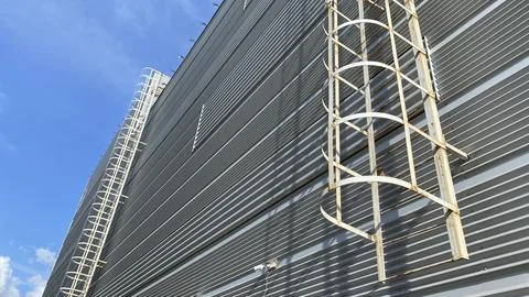 Safe ladder evacuation exit on building wall Stock Photos