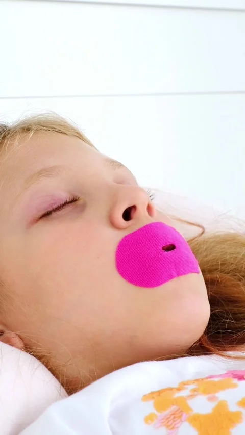 A safe mouth patch. Sleeping with your mouth taped shut. Healthy sleep for child Stock Footage 315943925