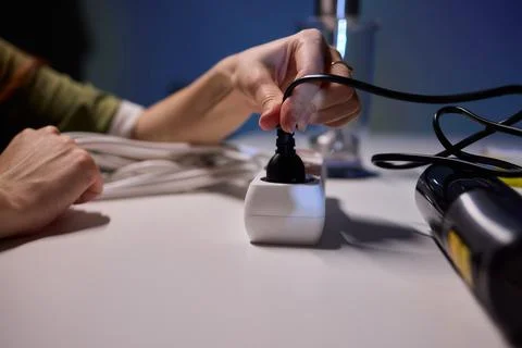 Safe plug connection demonstration, Careful connection of electrical device to Stock Photos